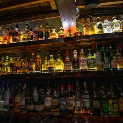 Various bottles on shelves behind the bar.