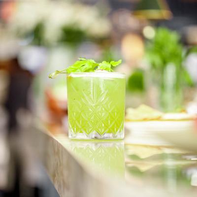 Cilantro margarita with a cilantro sprig garnish.