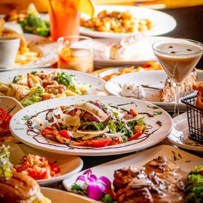 Assortment of food dishes and cocktails arranged on a table.