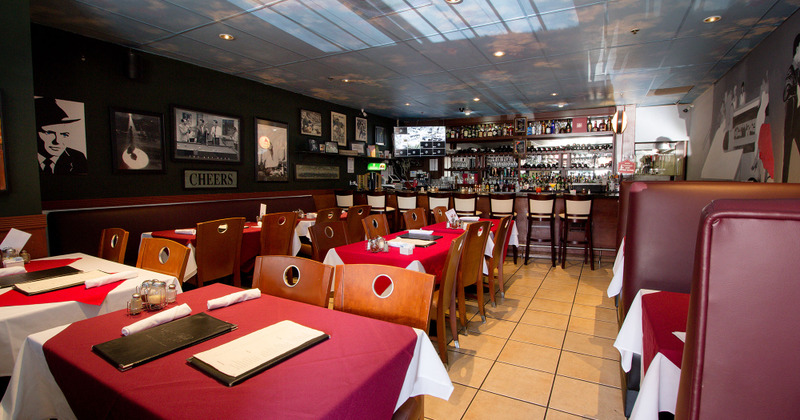 Dining area with a bar in the background
