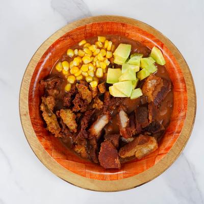 Fried bacon with beans, plantains, sausage, corn, and avocado.