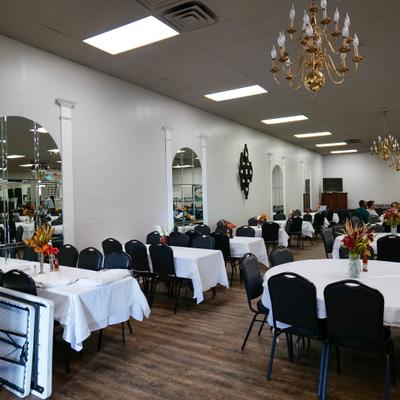 Interior with tables, chairs and mirrors on the walls.