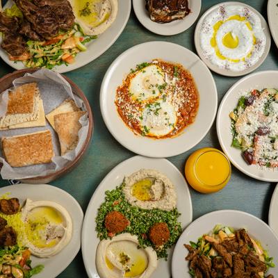 Assorted food plates on a table, top down view.