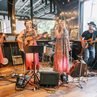 Musicians performing together on an indoor stage.