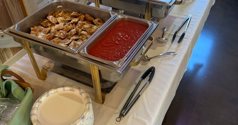 Buffet setup with a variety of warm dishes and condiments