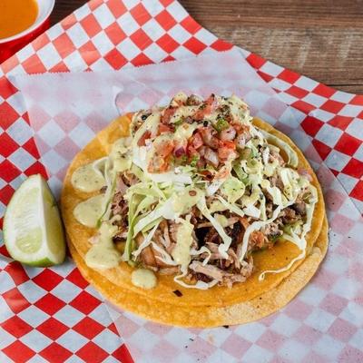 1 large taco with lime wedge, salsa.