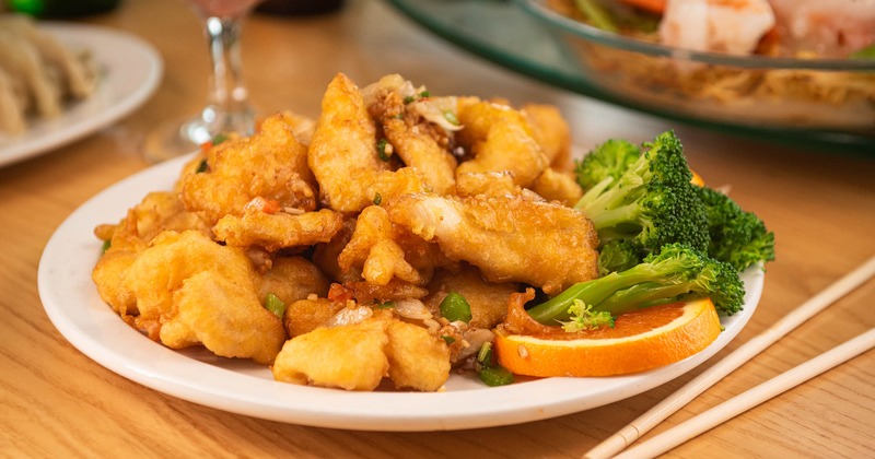 Lightly breaded chicken strips stir-fried with minced garlic and onions