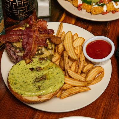 Brave Combo Burger served with fries and a dipping sauce.