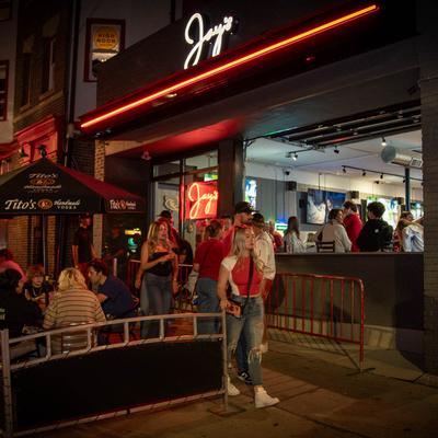 A crowd on the sidewalk outside.