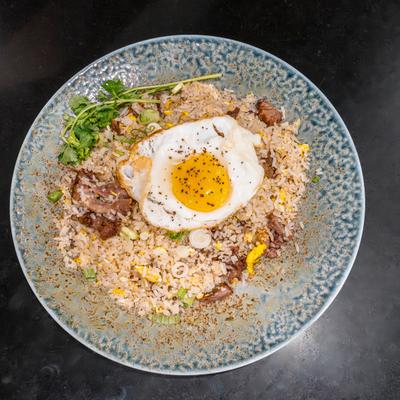 Oxtail fried rice topped with a sunny-side-up egg.