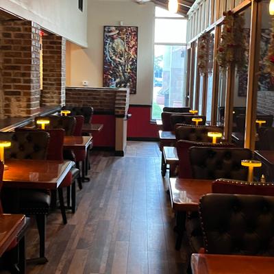 Interior with brick walls, boots with tables and wall decorations.