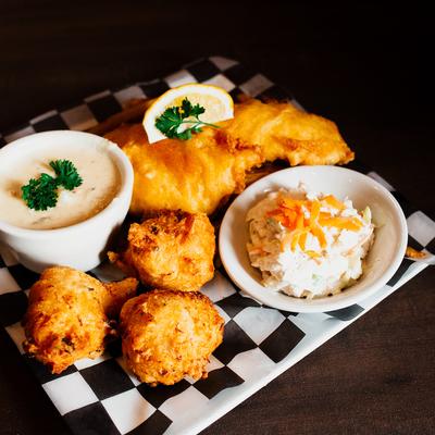 Fish and chips, coleslaw and chowder on the plate