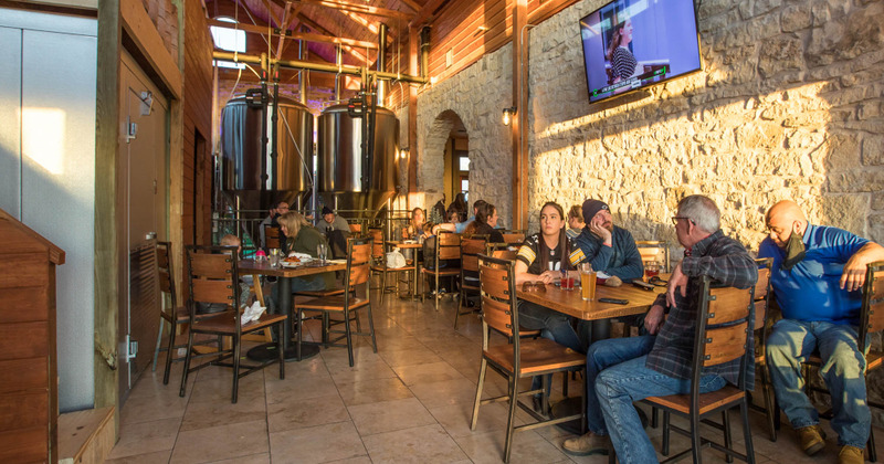 Guest sitting next to the beer barrels