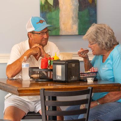 A couple of diners enjoying food and conversing.