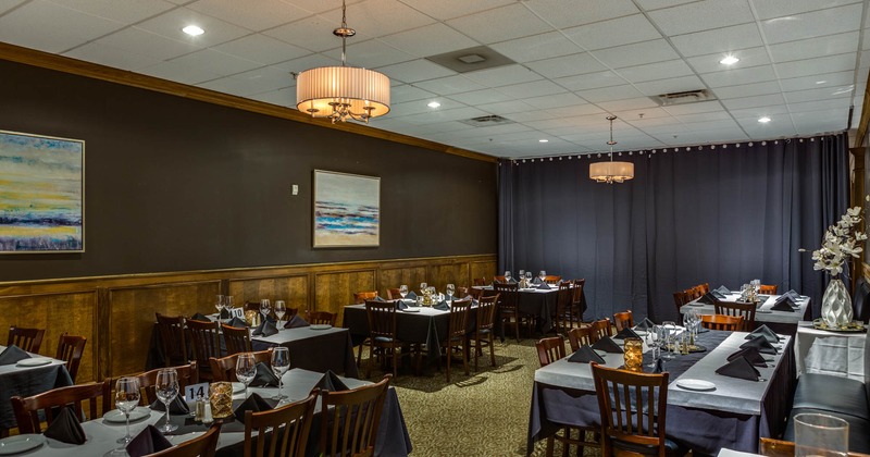 Interior, tables with black tablecloths and chairs