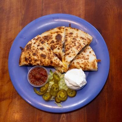 Chimichurri Steak Quesadillaserved with two dips, jalapenos and lettuce.