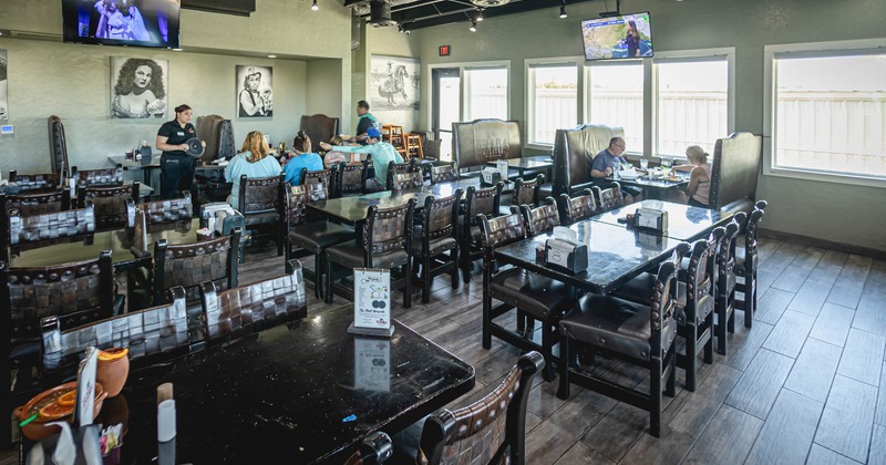 Interior, guests dining, a staff member taking an order