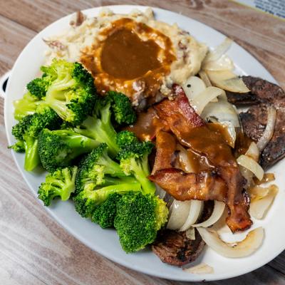Liver, onions, broccoli, mashed potatoes, and gravy.