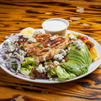 Cobb Salad served with a dressing.