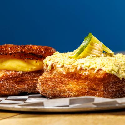 Creme Brulee and Key Lime Pie Croissant Donuts served on a plate.