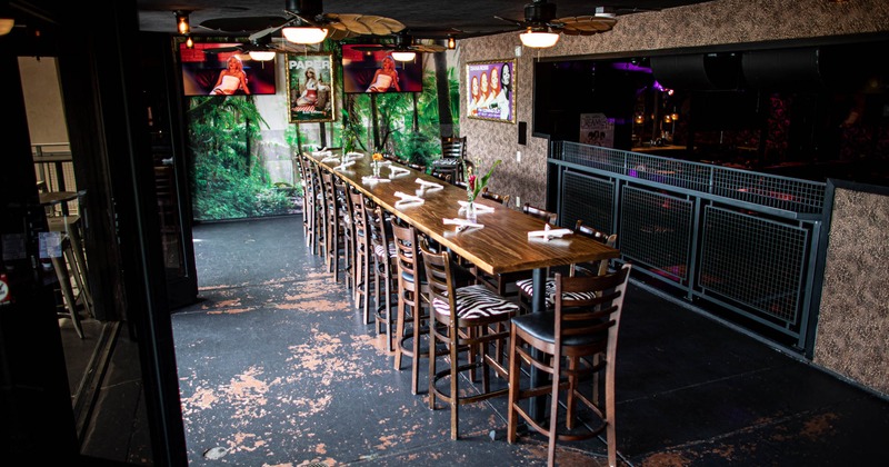 Interior, upstairs seating area, high wooden top table for eighteen people