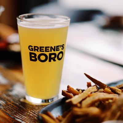 Hazy craft beer in a Greene’s Boro pint glass served with fries.