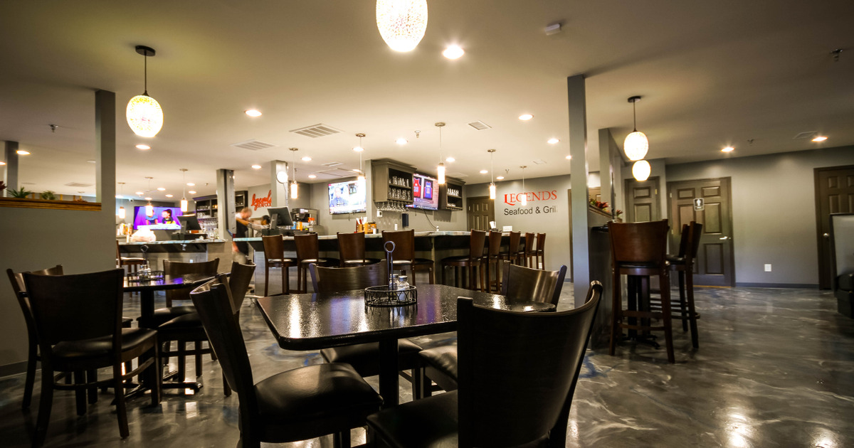 Indoor dining area with a bar in the background