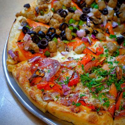 Pizza with assorted meats and vegetables.