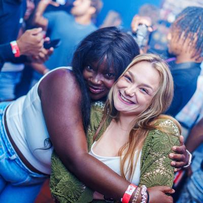 Guests standing and hugging for a photo.