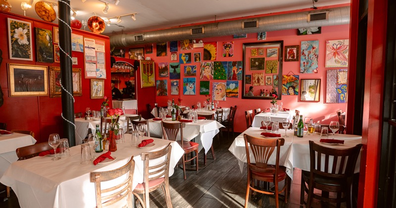 Vivid and cozy interior dining area with dining tables set for guests