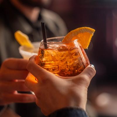 Customers toasting with cocktails.
