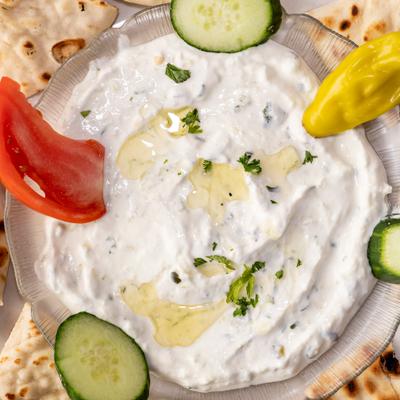 A serving of tzatziki served with pita bread.