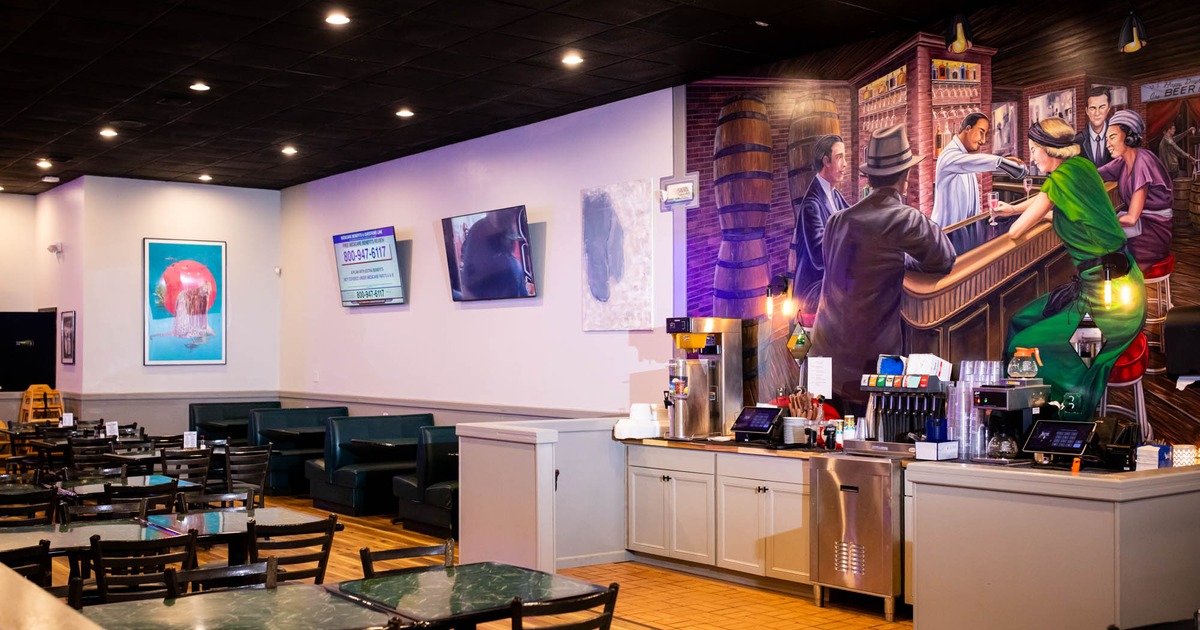 Interior, dining area and booth area, big mural on the wall