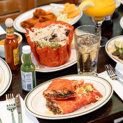 Various served meals and drinks on the table.