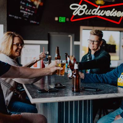 Friend toasting with drinks.