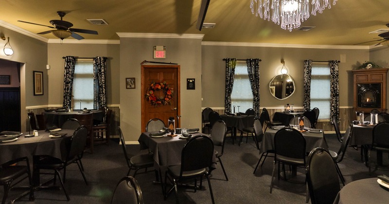 Interior, tables set for guests in dining area