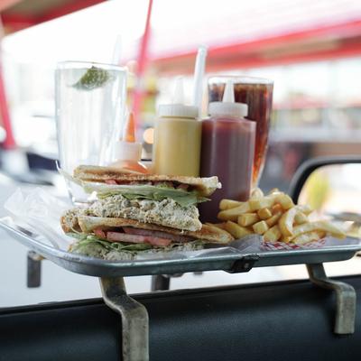 tuna fish sandwich with french fries at a car.