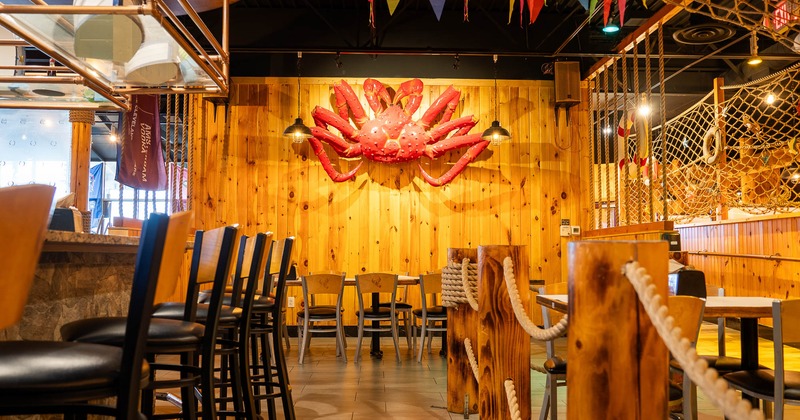 Interior, tables and chairs, big crab on the wall