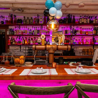 Interior, place setting at the bar counter with an employee.