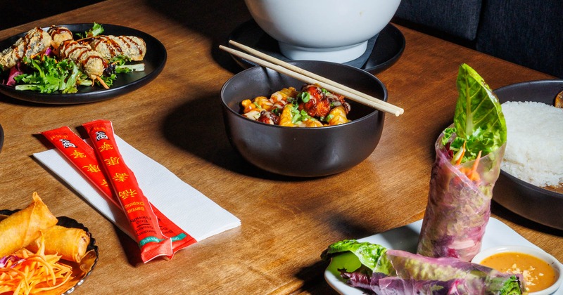 Assorted dishes including spring rolls and noodle bowl