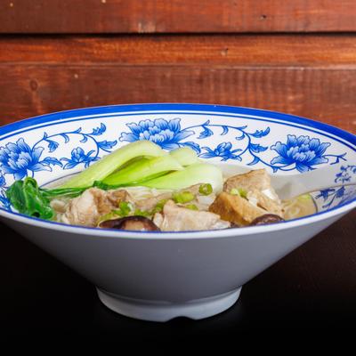 Noodle soup with beef, bok choy, and scallions.