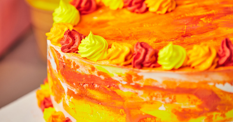 Cake with red, orange and yellow whipped cream