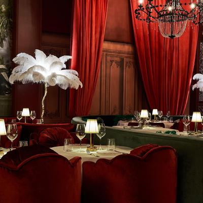 Interior with with red velvet curtains and 1950s-style furniture.