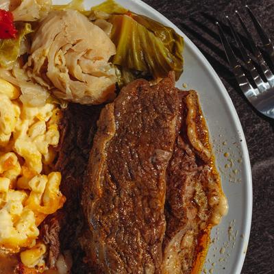 Braised Beef Short Rib plate, cabbage, mac and cheese, top view close up.