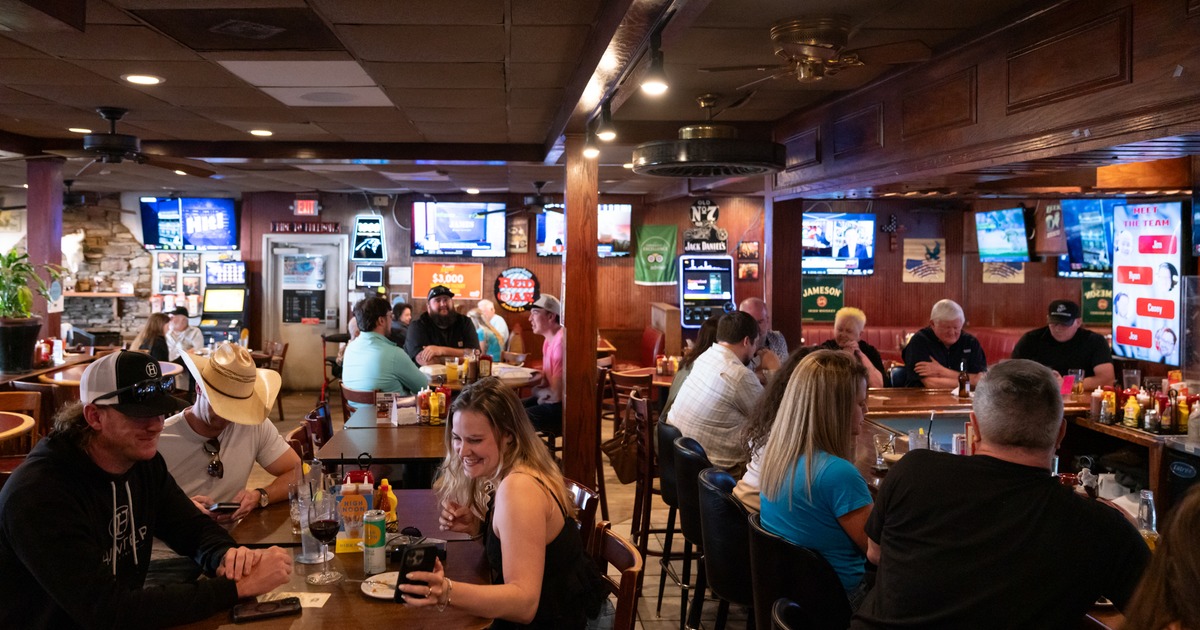Diner and bar area, tables, guests, wide view