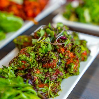 Close-up view of green chili fried chicken.