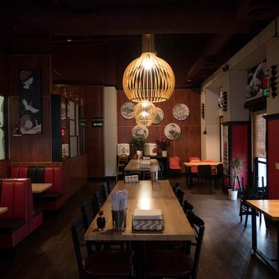 Dining area featuring tables and booths, with lots of Japanese wall decorations.