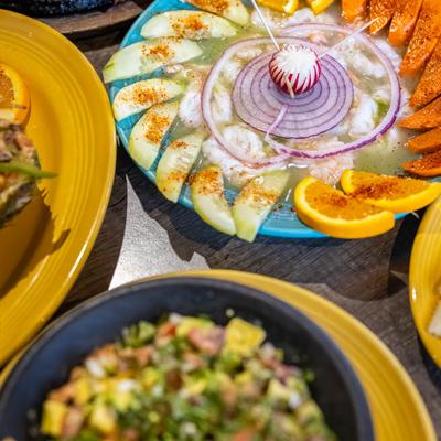 Aguachiles on a table with other dishes.