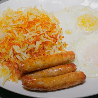 Fried eggs, sausages, and hash browns.
