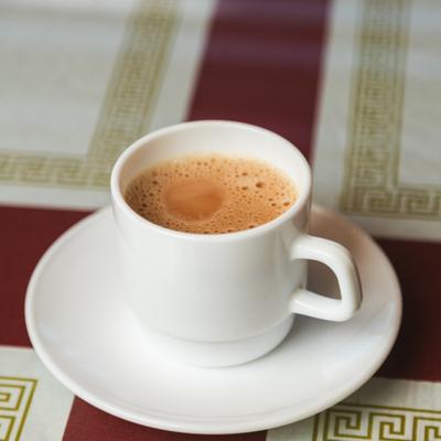 Chai Tea served in a small white cup and a matching saucer.